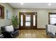 Cozy living room featuring a decorative fireplace, comfortable seating, and natural light from the windows at 4002 Guilford Ave, Indianapolis, IN 46205