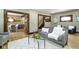 Cozy living room features hardwood floors, a comfortable gray sofa, and glass coffee table at 4002 Guilford Ave, Indianapolis, IN 46205
