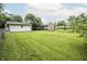 Large backyard featuring a lush green lawn and mature trees offering shade and privacy at 4020 Alden Ave, Indianapolis, IN 46221