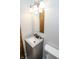 Bathroom featuring a granite vanity sink, framed mirror with lighting, and a modern toilet at 4020 Alden Ave, Indianapolis, IN 46221