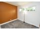 Cozy bedroom with carpet flooring, a white accent wall, and natural lighting at 4020 Alden Ave, Indianapolis, IN 46221