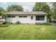 Well-maintained home featuring a well-manicured lawn, mature trees, and cozy curb appeal at 4020 Alden Ave, Indianapolis, IN 46221