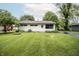 Well-maintained home featuring a well-manicured lawn, mature trees, and cozy curb appeal at 4020 Alden Ave, Indianapolis, IN 46221