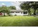 Charming home featuring a well-manicured lawn, mature trees, and a cozy exterior at 4020 Alden Ave, Indianapolis, IN 46221
