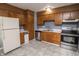 This kitchen features wood cabinets, stainless steel appliances, and modern tile flooring at 4020 Alden Ave, Indianapolis, IN 46221