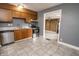 Kitchen showcasing wood cabinets, stainless steel appliances, and a view into the living space at 4020 Alden Ave, Indianapolis, IN 46221