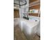 Functional laundry room with a washer, dryer, and shelving for optimal storage at 4020 Alden Ave, Indianapolis, IN 46221