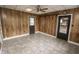 An interior room features wood paneling and contrasting tile floor and ceiling fan at 4020 Alden Ave, Indianapolis, IN 46221