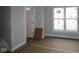 Unfinished bedroom space showcasing natural light from the window, with a door leading to another room at 4151 Barrel Ln, Westfield, IN 46062