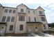 Modern townhome with cream colored exterior, black window trim and black roof at 4151 Barrel Ln, Westfield, IN 46062