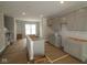 Kitchen area with unfinished cabinets, island, and stainless steel appliances at 4151 Barrel Ln, Westfield, IN 46062
