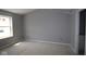 Bright bedroom featuring a window, base trim, and interior door at 4171 Barrel Ln, Westfield, IN 46062