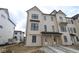 New two-story townhome features neutral siding, black trimmed windows, and covered front entry at 4181 Barrel Ln, Westfield, IN 46062