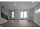 Spacious living room featuring large windows and a staircase with dark railing at 4181 Barrel Ln, Westfield, IN 46062