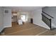 Open-concept living space with access to kitchen and staircase with dark railing at 4181 Barrel Ln, Westfield, IN 46062