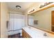 This bathroom features double sinks, a toilet, and a shower with a white curtain for privacy and comfort at 4287 Gibbs Rd, Danville, IN 46122