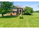 Beautiful brick home showcases a lush green lawn and mature trees at 4287 Gibbs Rd, Danville, IN 46122