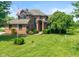 Charming two-story brick home featuring an inviting front yard and an American flag at 4287 Gibbs Rd, Danville, IN 46122