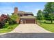Attached two-car garage with brick exterior and a paved driveway at 4287 Gibbs Rd, Danville, IN 46122