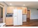 Kitchen features wood cabinetry, white appliances, and ample storage at 4287 Gibbs Rd, Danville, IN 46122