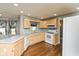 Bright kitchen featuring wood cabinets, white appliances, and ample counter space at 4287 Gibbs Rd, Danville, IN 46122