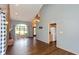 Open-concept living area with a brick fireplace, large windows, and hardwood floors at 4287 Gibbs Rd, Danville, IN 46122
