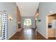 Cozy living room featuring wood flooring, a brick fireplace, and large windows at 4287 Gibbs Rd, Danville, IN 46122