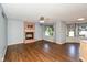 Living room showcasing hardwood floors, fireplace, and large windows with decorative curtains at 4287 Gibbs Rd, Danville, IN 46122