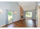 Bright living room with hardwood floors, brick fireplace, and large windows with backyard views at 4287 Gibbs Rd, Danville, IN 46122