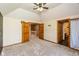 Spacious carpeted bedroom with vaulted ceiling, fan, and views of the hallway, door and bathroom at 4287 Gibbs Rd, Danville, IN 46122