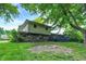 A home featuring a backyard with a firepit, a deck, and a combination of brick and vinyl siding at 4570 Moccosin Pl, Greenwood, IN 46142