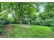Spacious backyard with mature trees and a cozy fire pit for outdoor entertaining at 4570 Moccosin Pl, Greenwood, IN 46142