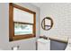 Bathroom featuring a vanity, wood trimmed window, round mirror, and subway tile backsplash at 4570 Moccosin Pl, Greenwood, IN 46142