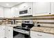 Updated kitchen with modern appliances, granite countertops, and stylish backsplash at 4570 Moccosin Pl, Greenwood, IN 46142