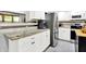 Bright kitchen boasts white cabinets, stainless steel appliances, and granite countertops at 4570 Moccosin Pl, Greenwood, IN 46142