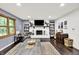 Cozy living room featuring a fireplace, accent wall, and hardwood floors at 4570 Moccosin Pl, Greenwood, IN 46142