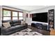 Comfortable living room featuring a plush sofa, a large window, and a flat-screen TV at 4570 Moccosin Pl, Greenwood, IN 46142