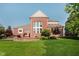 The backyard features a brick house, a green lawn, a brick patio with a hot tub, and a fire pit at 4617 S Cobblestone Dr, Zionsville, IN 46077