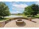 Beautiful backyard featuring an outdoor firepit, lovely landscaping, and serene water views at 4617 S Cobblestone Dr, Zionsville, IN 46077