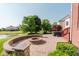 The backyard is made of brick and features a hot tub, red stairs, a fire pit, and a view of a pond at 4617 S Cobblestone Dr, Zionsville, IN 46077
