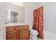 A cozy bathroom with a floral curtain, wooden vanity and sink with white countertop, and a neutral-toned tile floor at 4617 S Cobblestone Dr, Zionsville, IN 46077