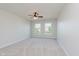 Large bedroom with a ceiling fan, plush carpet, and two windows allowing in natural light at 4617 S Cobblestone Dr, Zionsville, IN 46077