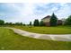 View of the backyard and a paved path showcasing the home's well-maintained landscaping and surrounding green space at 4617 S Cobblestone Dr, Zionsville, IN 46077
