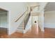 Bright foyer features staircase with wood and iron railing, hardwood floors, and an open floor plan at 4617 S Cobblestone Dr, Zionsville, IN 46077