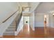 Bright foyer featuring hardwood floors, staircase, and views to the living areas at 4617 S Cobblestone Dr, Zionsville, IN 46077
