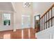 Bright, two-story foyer with hardwood floors and a view of the front door at 4617 S Cobblestone Dr, Zionsville, IN 46077