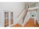 This beautiful home features an elegant staircase, hardwood floors, and wainscoting detail at 4617 S Cobblestone Dr, Zionsville, IN 46077