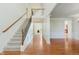 The foyer showcases hardwood floors, an elegant staircase, and detailed wainscoting, highlighting the home's charm at 4617 S Cobblestone Dr, Zionsville, IN 46077
