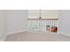 Hallway with wood railing, carpet, and view of the exterior at 4617 S Cobblestone Dr, Zionsville, IN 46077