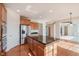 Spacious kitchen with island, stainless steel refrigerator, and wood flooring at 4617 S Cobblestone Dr, Zionsville, IN 46077